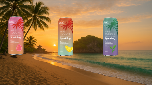 Mrs. Toddy’s Sparkling Botanical Tonics – Guava, Lemon, and Matcha – set against a tropical beach sunset, highlighting real ingredients like ginseng, gingko, and lemongrass for natural vitality and clean energy
