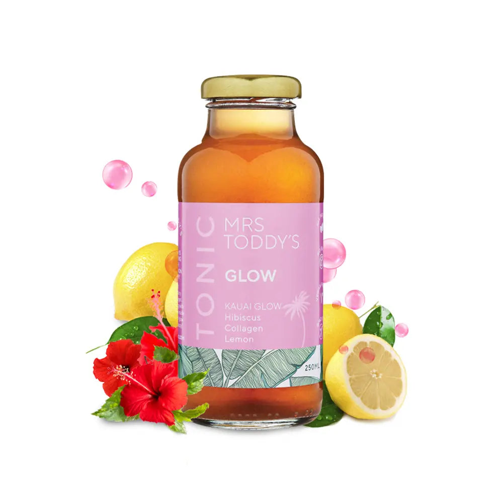 Glow Tonic bottle on neutral background with botanical ingredients